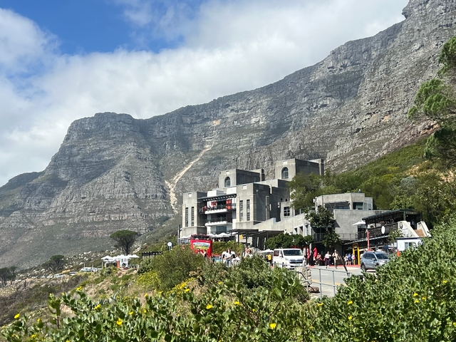 View of a mountain with a large modern building at the base.