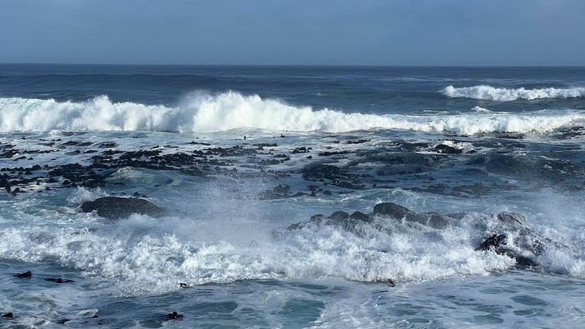       Waves crashing on rocky shore.
  