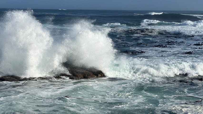       Ocean waves crashing on rocks.
  