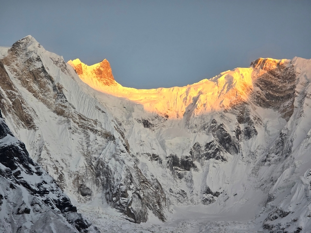 Snow-covered mountains with warm sunlight at the peaks.