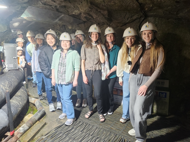 Group of people wearing helmets inside a tunnel.