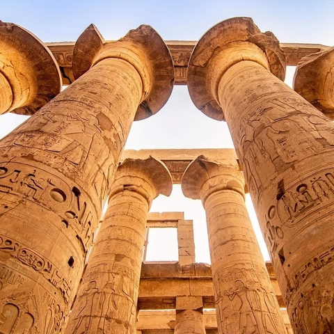 Close-up view of ancient Egyptian columns with detailed hieroglyphs.