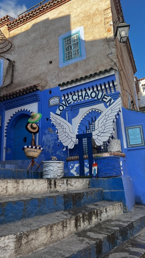 Decoratively painted wall with a love-themed mural in blue.