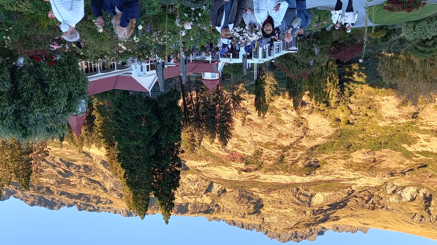 Outdoor dining with mountains in the background.