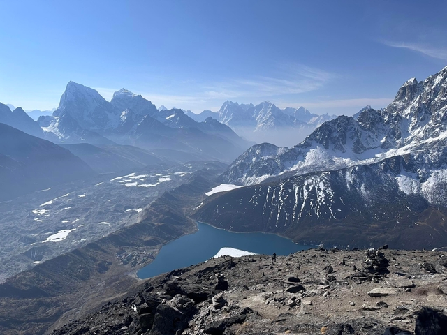 Spectacular view of snow-capped mountains and a lake from a high altitude.