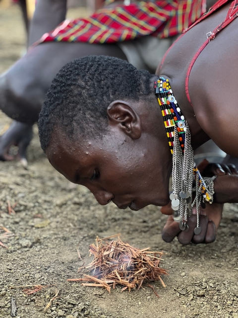       Close-up of a person wearing traditional beaded accessories.
  