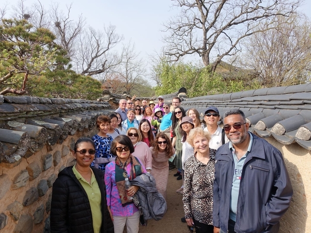 Group of tourists walking through a traditional alleyway.