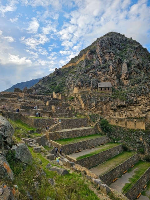       Ancient ruins on a mountainside with the surrounding landscape.
  