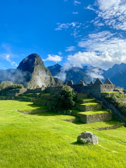Iconic ancient ruins with a mountainous backdrop.