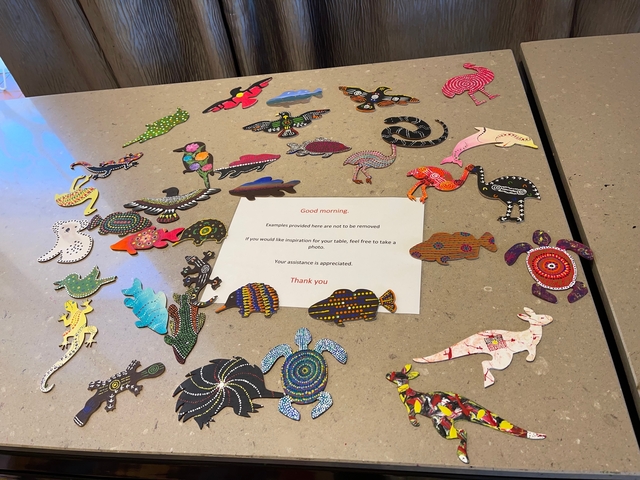       Various colorful artworks laid on a surface.
  