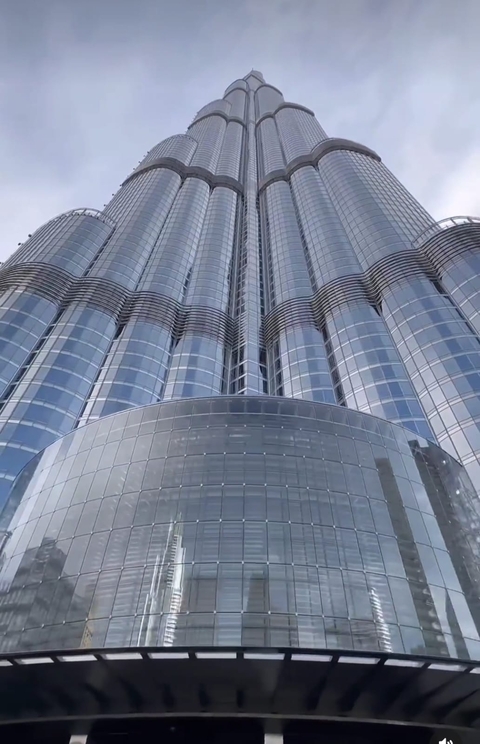 Top-down view of a modern glass skyscraper building.