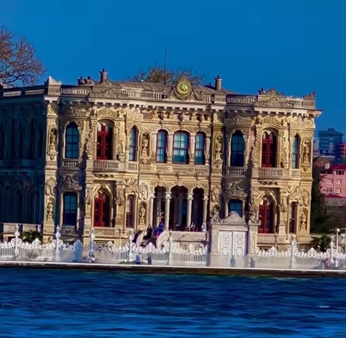       Ornate building with detailed facade and pillars.
  