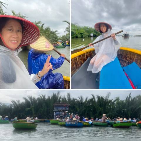 People in bamboo boats on a river, wearing raincoats.