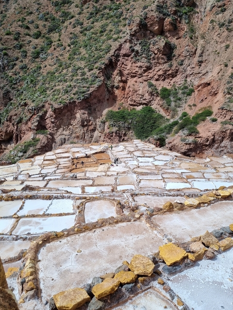       Salt evaporation ponds with tourists visiting.
  