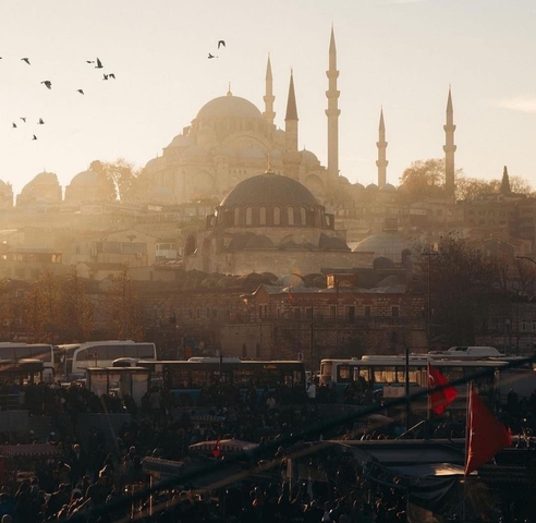 Scenic view of a historic mosque in a bustling city.