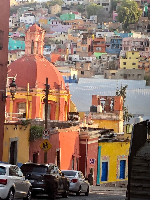       Colorful buildings with a domed structure in an urban setting.
  