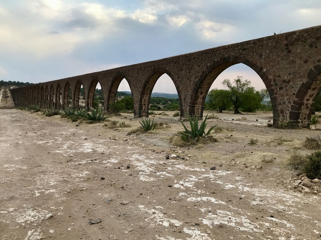       Ancient aqueduct in a dry landscape.
  