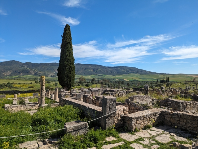Ancient ruins with scenic landscape and clear sky.