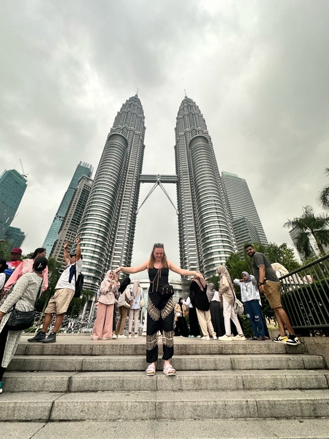 Woman in front of the Petronas Towers.