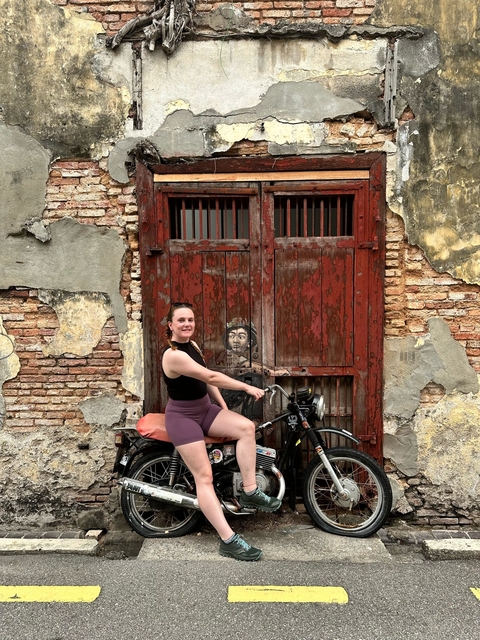 Woman posing on a mural bike installation.