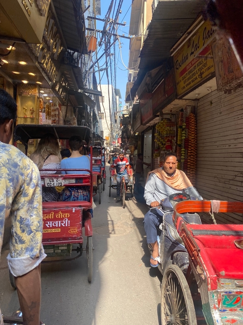 Busy street with rickshaws and people.