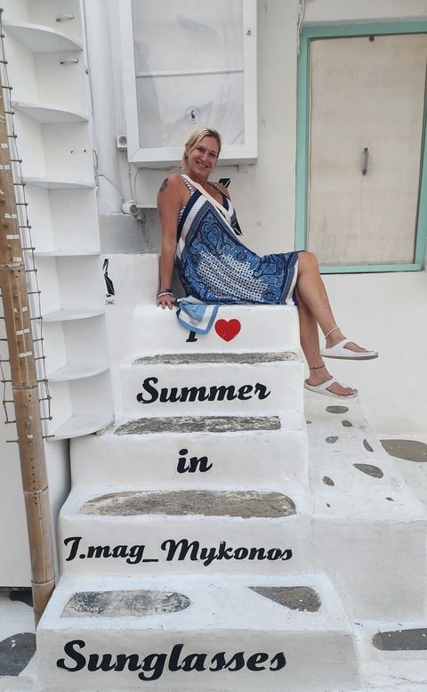 Person sitting on steps with 'I love Summer' painted on it.
