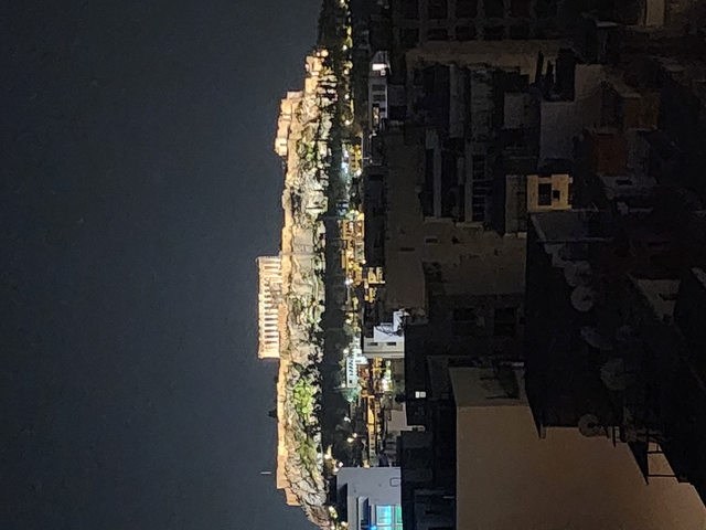       Night view of ancient city ruins with lights.
  