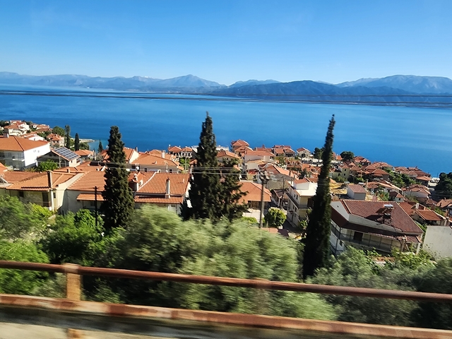       Hillside view with Mediterranean sea and houses.
  