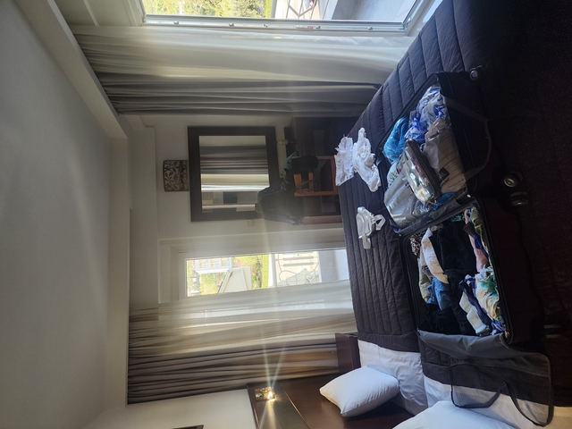       Interior view of a room with a suitcase on the bed.
  