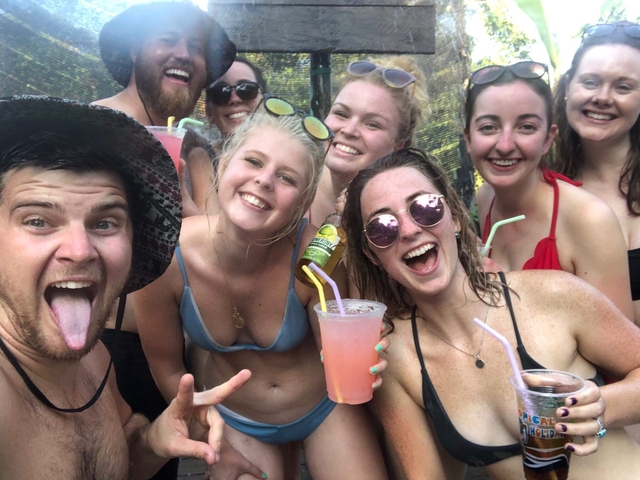       Group of young people having drinks and smiling.
  