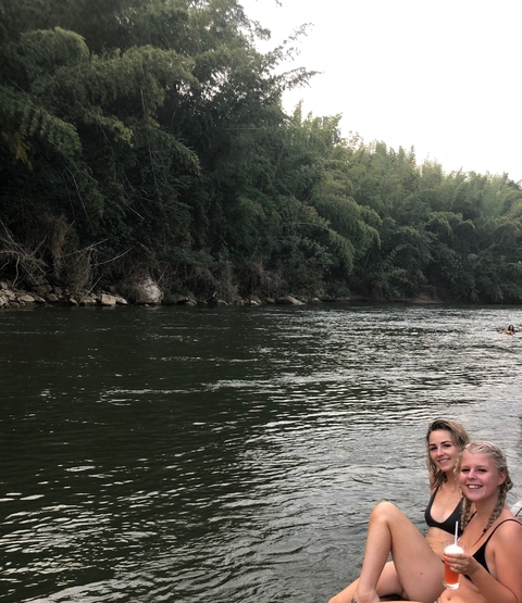 River scene with partial view of a person and trees.