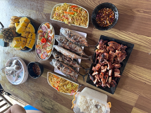 Array of cooked and uncooked food items on a wooden table.