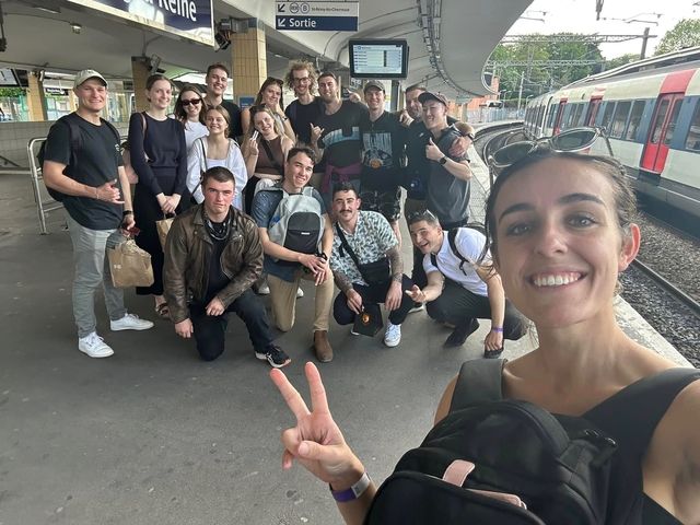 Group of travelers posing at a train station.