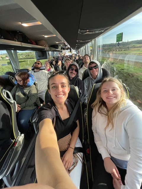 Group selfie in a bus setting.