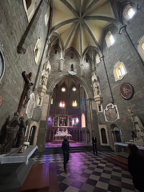 Interior of a historic church with stained glass windows.