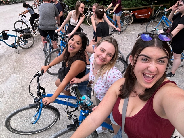 Group of young women posing with bicycles.