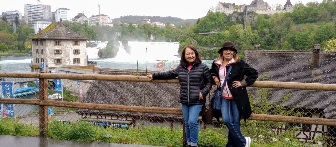Two women in front of Rhine Falls.