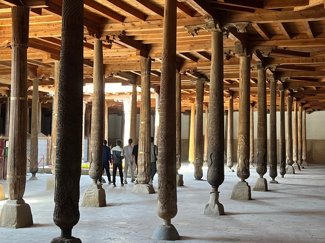       Intricate wooden columns in a historical building's interior.
  