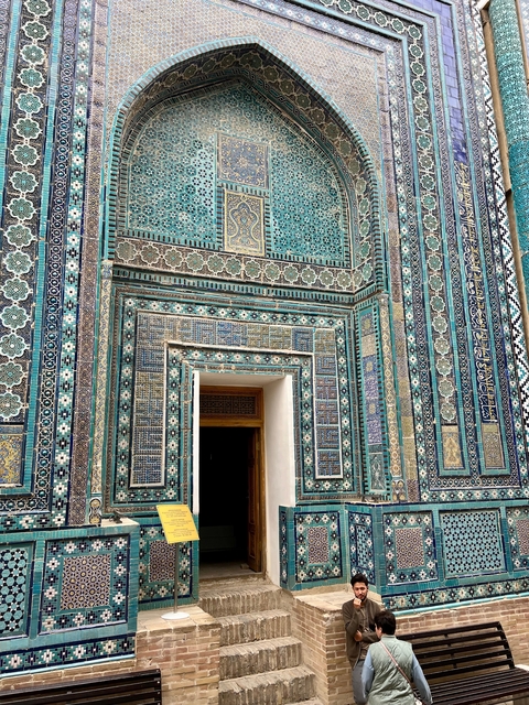 Close-up of mosaics and decorative tiles on a historical building.