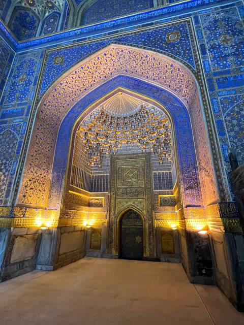       Interior of a beautifully decorated mosque with golden accents.
  