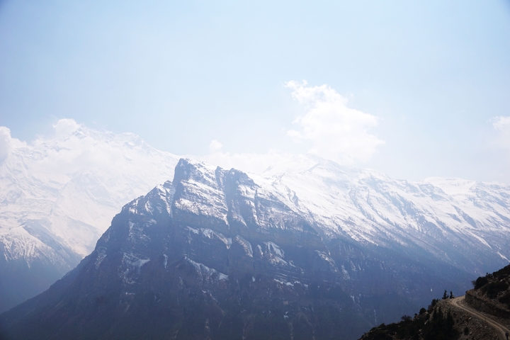 A stunning view of snow-covered mountains under a clear blue sky.