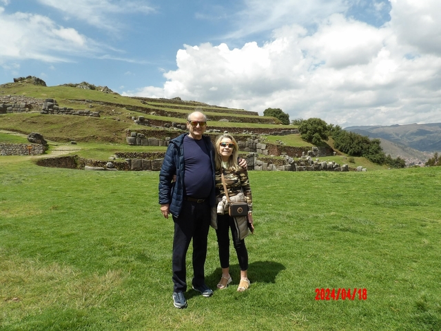 Couple posing at archaeological site with terraces.