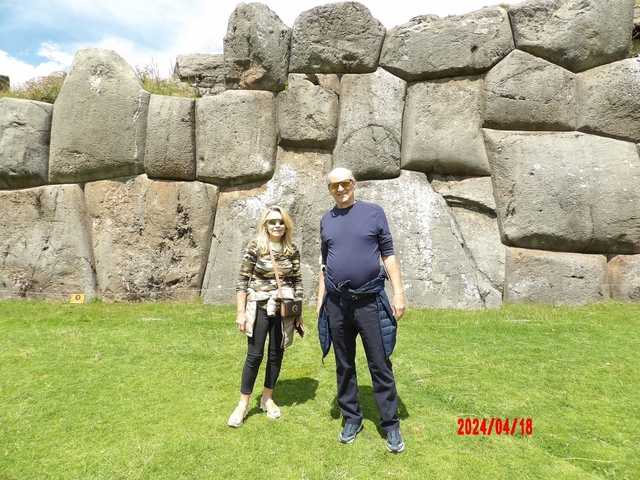 Couple in front of massive stone walls.