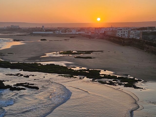 Scenic sunset view over a beach and ocean.
