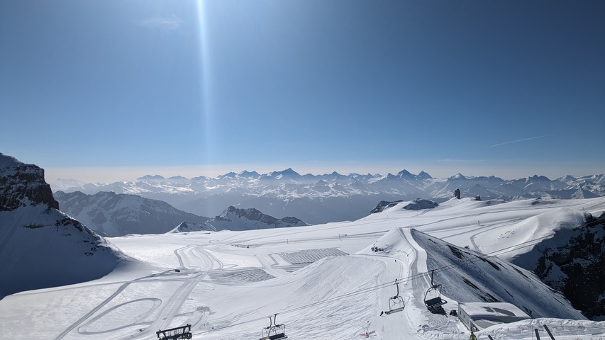 Snowy mountain landscape with clear blue sky.