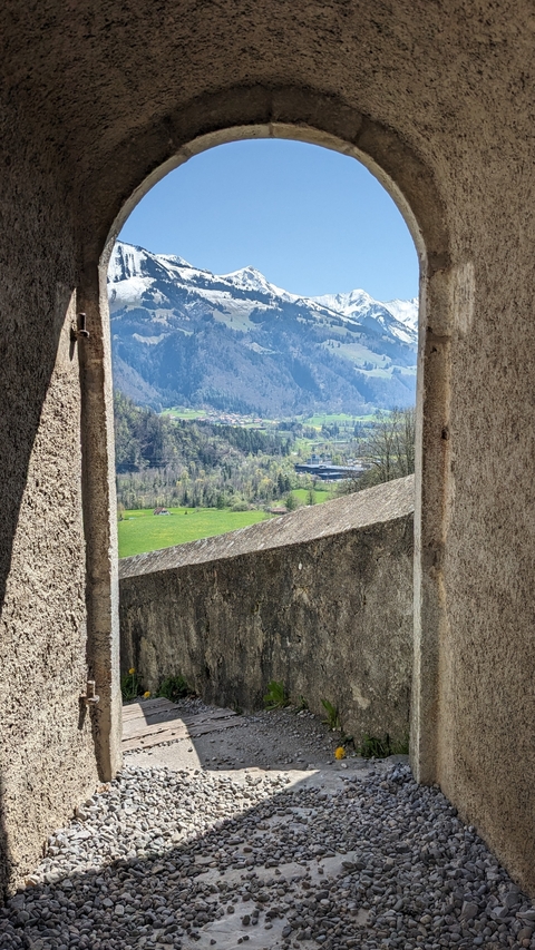 A scenic view of a valley from a window in a historic structure.