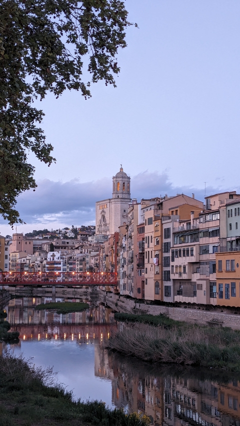 A town with colorful buildings and a prominent tower.