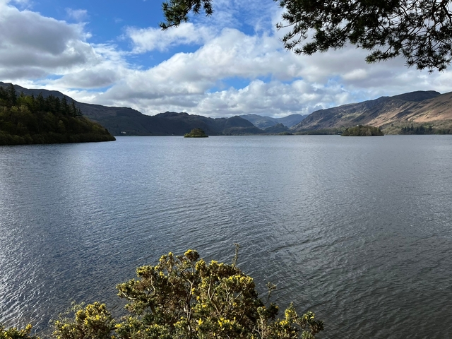 Peaceful lake scene with mountains in the background.
