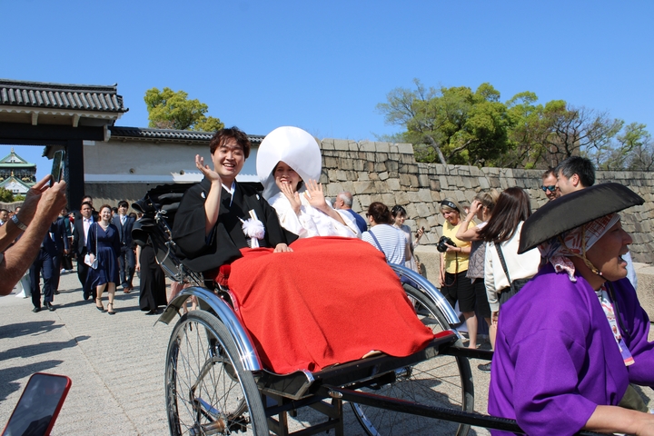       Traditional Japanese wedding procession with a rickshaw.
  