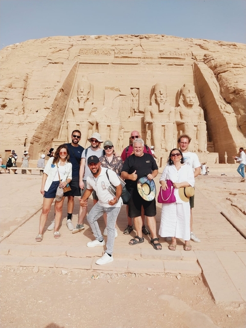       Tourists posing in front of Abu Simbel temples.
  